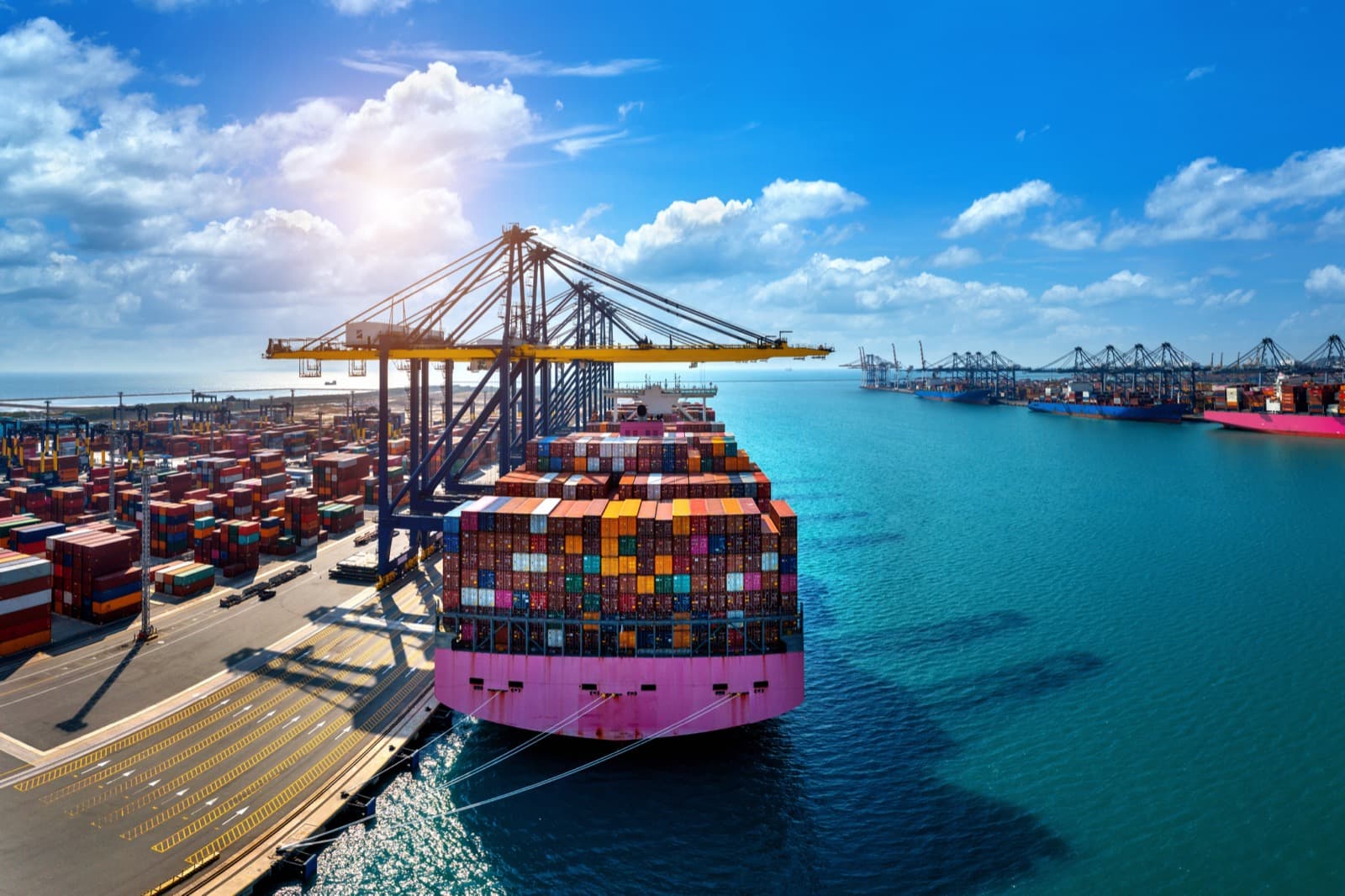 Container ship docked at a busy port